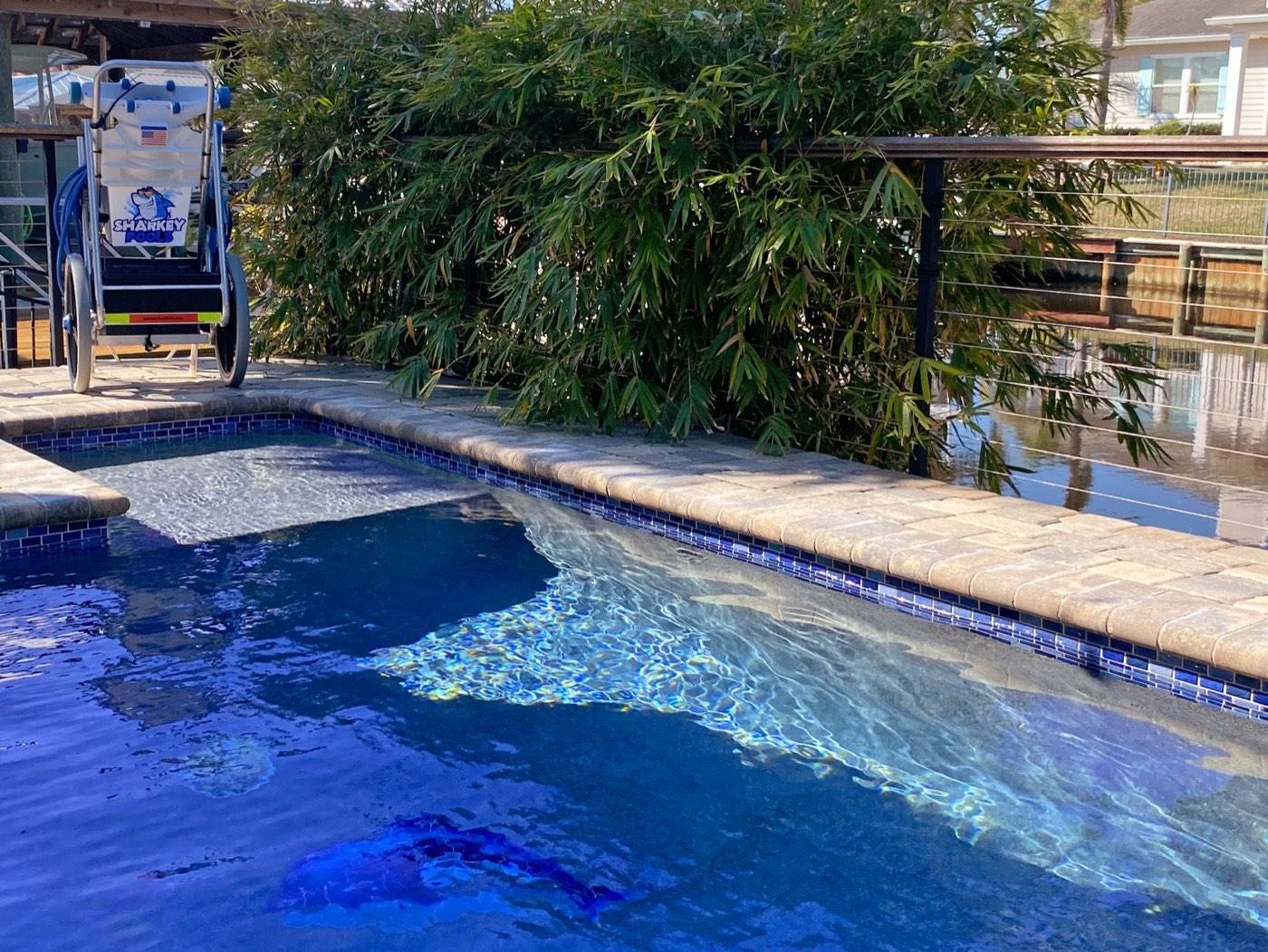 Clean pool in Jacksonville Beach with a Sharkey Pools cleaning cart