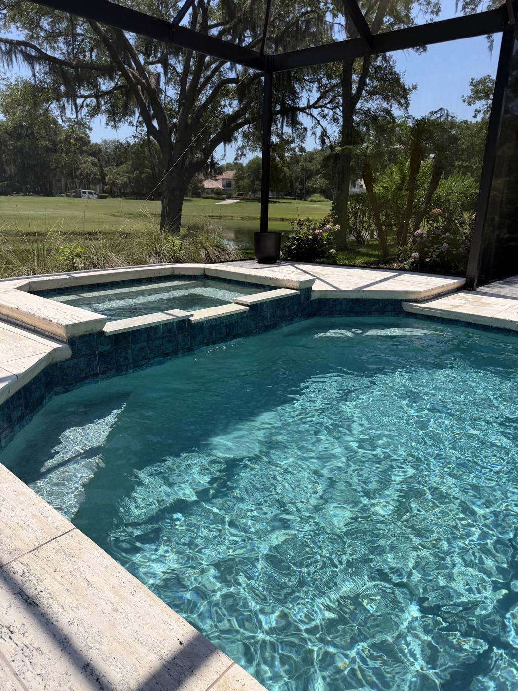 Clear pool with an attached raised spa
