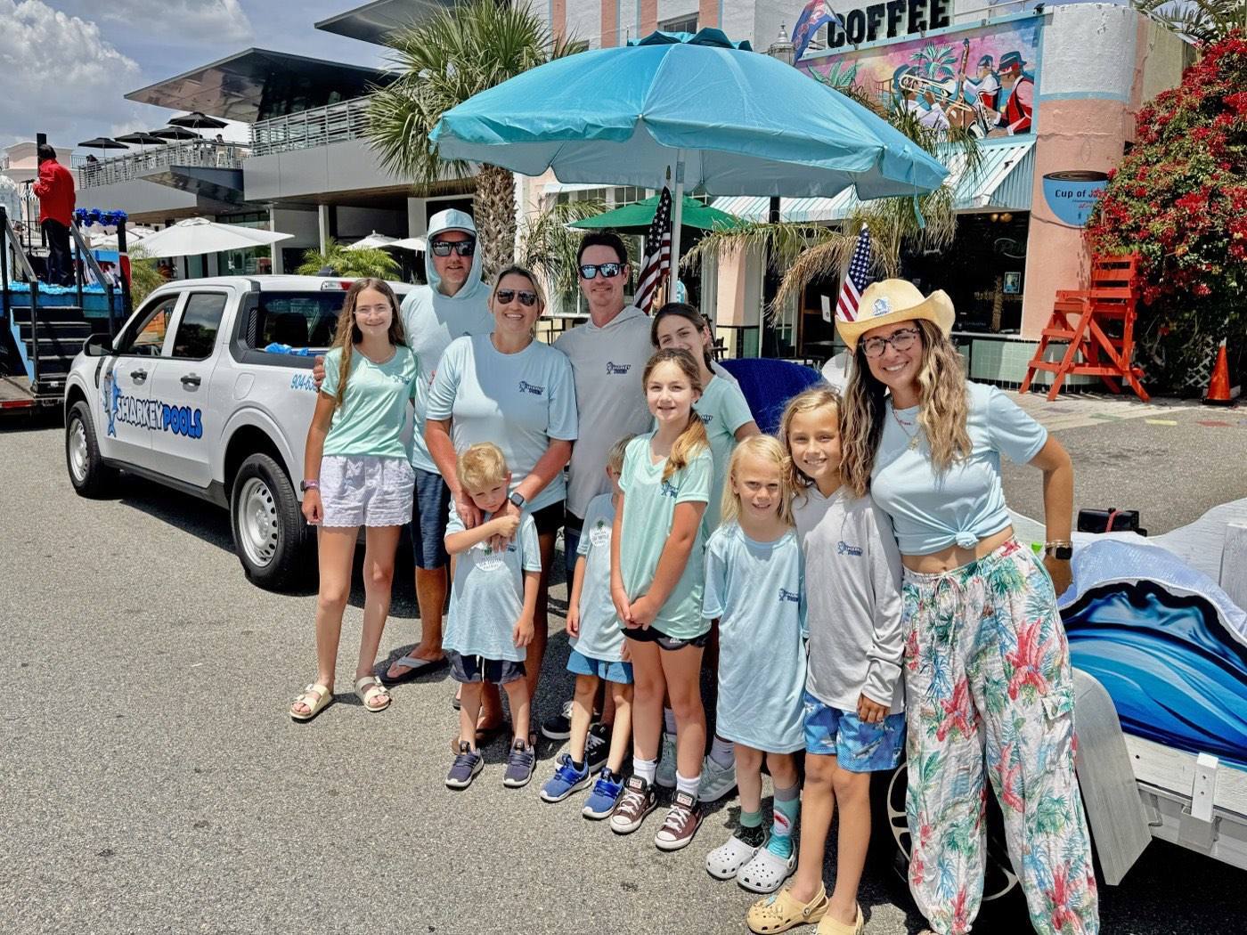 The Sharkey Pools family and crew with the Sharkey truck at the Opening of the Beaches parade